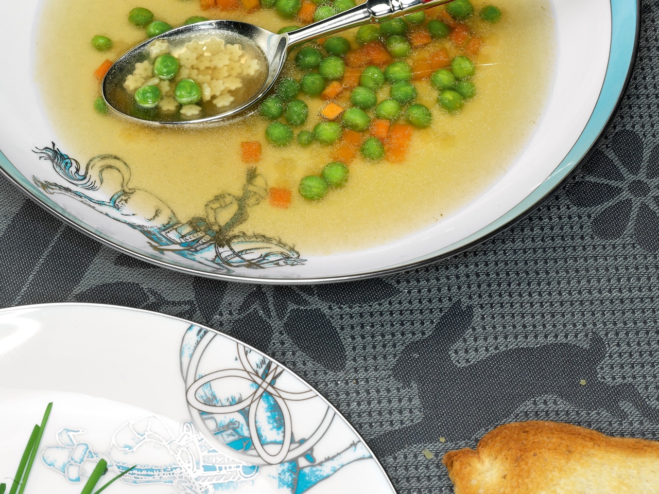 Consommé with Star-Shaped Noodles, Carrots, and Peas