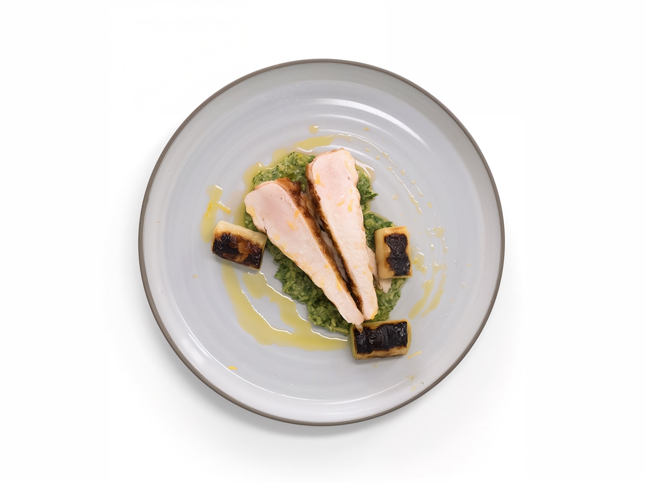 Grilled Chicken Breasts with Leek Confit and Seasonal Herb Pesto