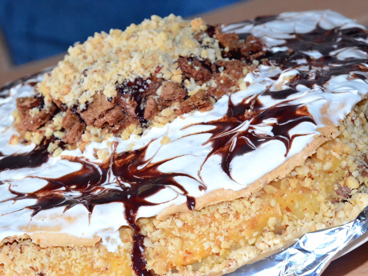 Meringue Cake with Milk Cream, Caramel, and Nuts