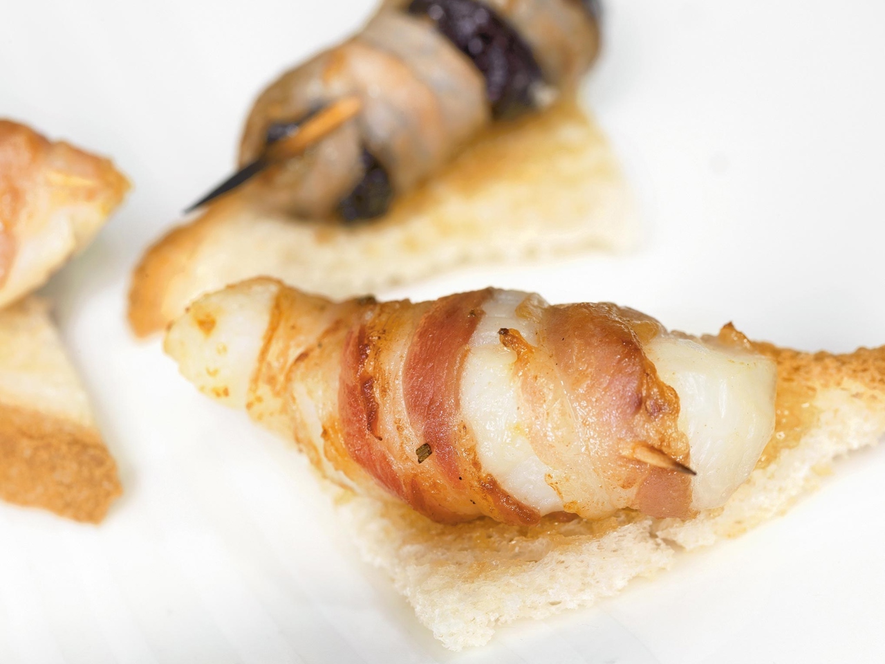 Scallop and Prune Rolls on Toasts