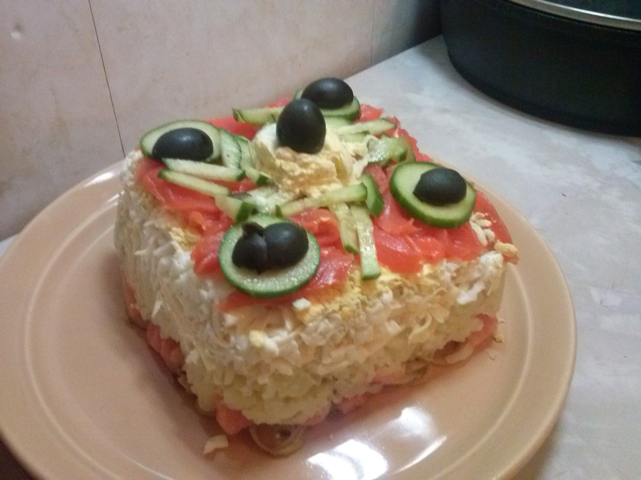 Layered Salad with Salmon, Eggs, and Potatoes under Mayonnaise