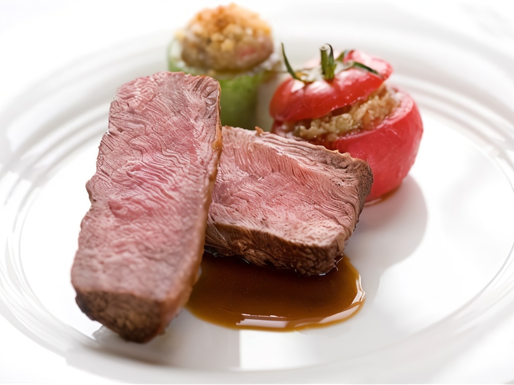 Baked Alpine Lamb Fillet with Tomatoes and Young Zucchini Stuffed with Eggplant